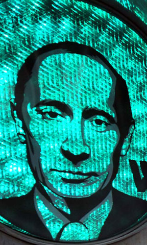 A green traffic light illuminates a transparent image of Russian Prime Minister Vladimir Putin, which was apparently stuck to the device by the Russian strongman’s supporters in central Moscow, February 13, 2012. Photo:ImagineChina