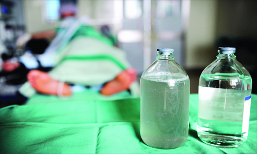Items used in a lung lavage operation for a black lung patient sit on a tray in the Xinjiang Occupational Disease Hospital. The bottle on the right shows clean water, used to wash the lungs, and the one on the left is the liquid collected after the procedure. Photo: CFP