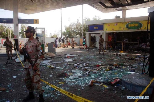 Security officials inspect the blast site in southern Pakistani port city of Karachi on Jan. 22, 2013. At least two people were killed and seven others were injured in gas cylinder blast on a fuel station in Karachi on Tuesday, local media reported. (Xinhua/Masroor) 