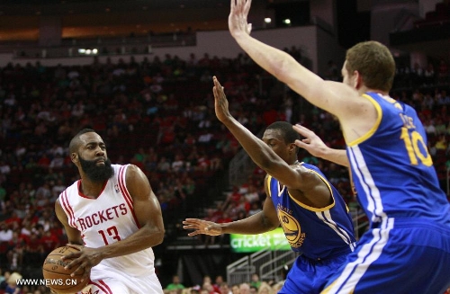 James Harden (L) of Houston Rockets competes during the NBA game against Golden State Warriors in Houston, the United States, on March 17, 2013. (Xinhua/Song Qiong) 