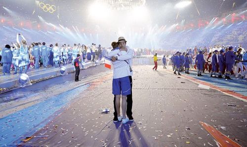 Two athletes hug during the athletes parade at the closing ceremony of the 2012 London Olympic Games in London on Sunday. Rio de Janeiro will host the 2016 Olympic Games. Photo: AFP