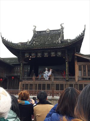 Visitors watch bamboo horse dancing in the old town.