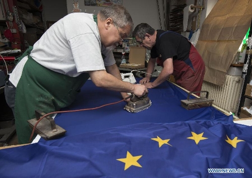 Workers of Cvirn Printing Company make EU flags for Croatia's EU entry celebration in Zagreb, capital of Croatia, June 28, 2013. Croatia is set to become the 28th member state of the European Union on July 1, 2013. (Xinhua/Miso Lisanin)