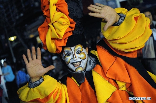 A dancer participates in the 2013 Carnival Inauguration Parade on the July 18 Avenue in Montevideo, capital of Uruguay, on Jan. 25, 2013. Various artists participate in the carnival, which attracts more than 100,000 people each year in the July 18 Avenue, according to the local press. (Xinhua/Nicolas Celaya) 