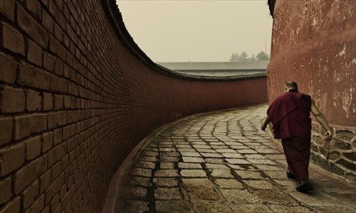 A monk walks around a temple on Wutai Mountain in Shanxi Province on September 22, 2011. Photo: IC