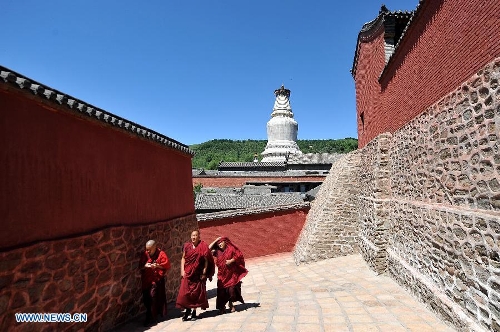 Monks walk to the Luohou Temple on Mount Wutai, one of four sacred Buddhist mountains in China, in north China's Shanxi Province, June 26, 2013. Added to UNESCO's World Heritage List in 2009, Mount Wutai is home to about 50 Buddhist temples built between the 1st century AD and the early 20th century. (Xinhua/Zhan Yan)
