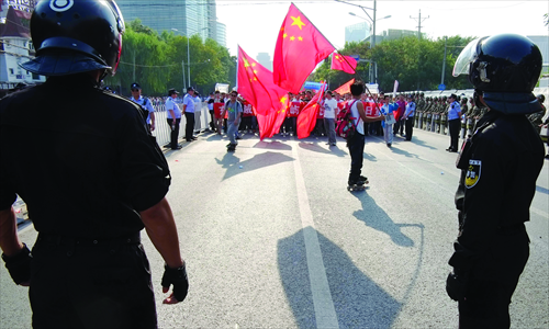 People march outside the Japanese embassy on Sunday. Photo: Zhang Siyang/GT