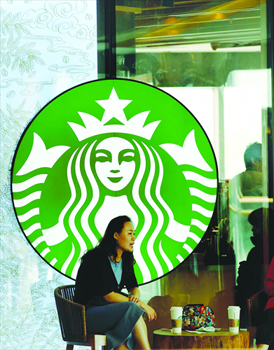 A customer chats inside a Starbuck store in Beijing on October 4. Photo: CFP