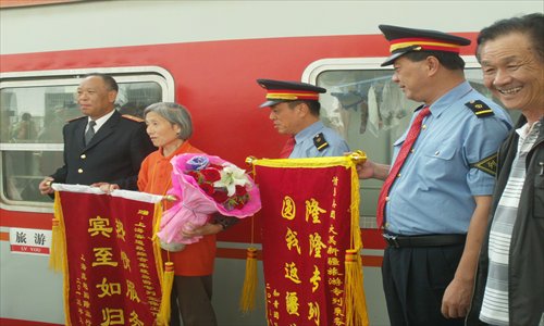Yang Yongqing and the crew of the train which took her and her comrades to the region where they had spent an influential part of their lives Photo: Courtesy of Yang Yongqing 

