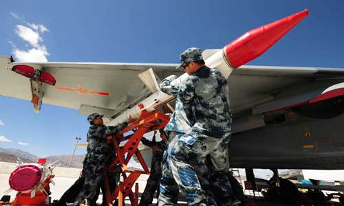 Engineers load missiles onto the J-11 jet fighter. Photo: mil.cnr.cn