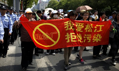 Local residents hold a red banner saying 