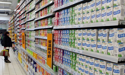 A woman buys milk in a supermarket in Ganyu, East China's Jiangsu Province on Monday. Photo: IC