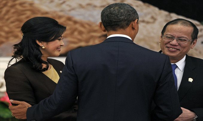 US President Barack Obama (center) greets Thai Prime Minister Yingluck Shinawatra (left) and Philippines President Benigno Aquino ahead of a family picture preceding the 7th East Asia Summit in Phnom Penh on Tuesday. Photo: AFP 