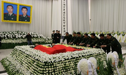 Thousands of firefighters and members of the public attend the funeral of firefighters Lu Chen, 23, and Sun Luoluo, 18, earlier this month. Photo: CFP