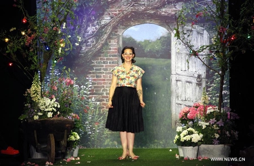 Austrian designer Lena Hoschek greets the audience at the Spring/Summer 2014 Shows of the Mercedes-Benz Fashion Week, in Berlin, on July 2, 2013. (Xinhua/Pan Xu) 