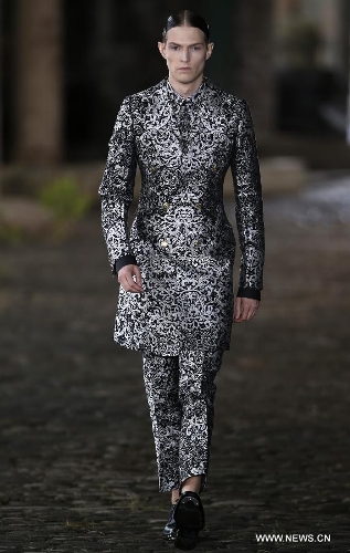 A model displays a creation during SS14 Alexander McQueen Menswear show at the Coal Drops, King's Cross in London, Britain on June 17, 2013. (Xinhua/Wang Lili) 