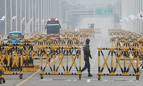A South Korean soldier walks past barricades on the road leading to North Korea's Kaesong joint industrial complex, at a military checkpoint in the border city of Paju on Saturday. Photo: AFP/Yonhap