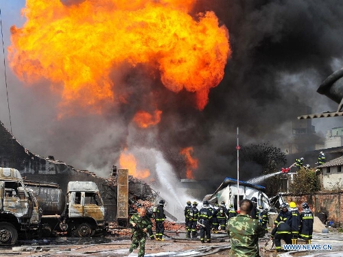Firefighters put out the fire at the accident site after an explosion ripped through a warehouse of a chemical factory in the Dongxihu District of Wuhan, capital city of central China's Hubei Province, April 13, 2013. The casualties were unknown. (Xinhua/Xiao Yijiu) 