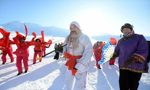 People perform traditional dance after snowfall at Jiangjunshan ski resort in Altay, northwest China's Xinjiang Uygur Autonomous Region, Dec. 28, 2012. Beautiful snow scenery here attracts a good many tourists. Photo: Xinhua