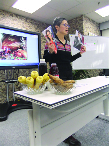 Porsher Cheung, founder of the Beijing Toastmasters Club, displays manuals for members at a meeting. Photo: Lin Kan Hsuan/GT