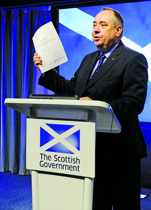 Scotland’s First Minister Alex Salmond holds up the signed agreement for a referendum on Scottish independence during a press conference in St Andrews House in Edinburgh on October 15. Photo: AFP 