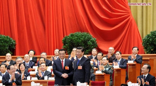 Xi Jinping shakes hands with Li Keqiang at the fifth plenary meeting of the first session of the 12th National People's Congress (NPC) at the Great Hall of the People in Beijing, capital of China, March 15, 2013. Li Keqiang was endorsed as the premier of China's State Council at the meeting here on Friday. (Xinhua/Liu Jiansheng)