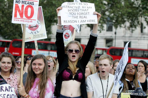 Women hold banners and shout slogans as they take part in a 