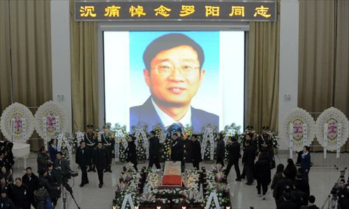 People attend a memorial service for Luo Yang, head of the production phase for China's new J-15 fighter jet, who died of a heart attack on November 25, in the Huilonggang Cemetery for Revolutionaries in Shenyang, capital of northeast China's Liaoning Province, November 29, 2012. Luo experienced a heart attack after observing aircraft carrier flight landing tests for China's first aircraft carrier, the Liaoning, on November 25. He later died in hospital at the age of 51. He was also chairman and general manager of Shenyang Aircraft Corp. (SAC), a subsidiary of China's state-owned aircraft maker, Aviation Industry Corp. of China (AVIC). Photo: Xinhua
