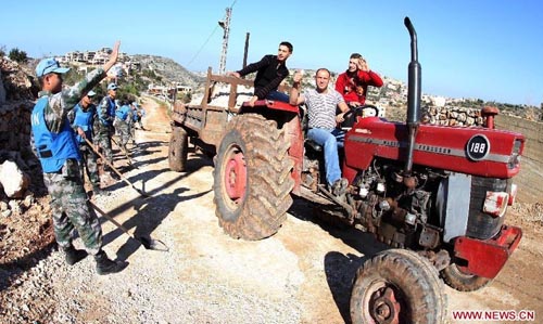Local citizens drive on a road built by Chinese peacekeeping sappers in Lebanon, Nov. 27, 2011. Over the two decades since it sent its first peacekeeping troop to Cambodia in April 1992, China has participated in more than 20 UN peacekeeping missions, dispatching a total of 20,000 soldiers. There are now nearly 2,000 Chinese peacekeepers carrying out their tasks in 12 peacekeeping missions. Chinese peacekeeping troops are formed by members of the People's Liberation Army (PLA), which will celebrate its 85th founding anniversary on August 1, 2012. Photo: Xinhua