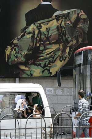 A Syrian man crosses a street in Damascus on Monday. Russia said it would not permit a no-fly zone to be implemented over Syria, following reports that plans for such a measure were being drawn up by the US. Photo: AFP