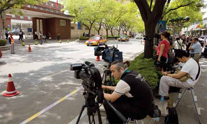 Members of the media gather inside a police cordon outside the Chaoyang Hospital in Beijing where Chinese activist Chen Guangcheng was staying on May 3. Chen appealed to US officials to help get him out of China. Photo: AFP