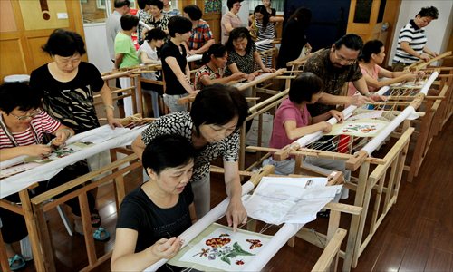 Fifteen apprentices finish up a three-month training class in Pudong New Area to learn Gaoqiao town's special style of wool embroidery. As one of Shanghai's special art forms, Gaoqiao wool embroidery is renowned for its detail, delicacy and color. Photo: Xinhua