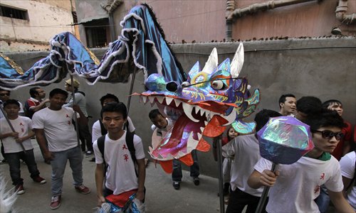 Chinese and Indian students walk in a procession with a dragon mask during Chinese New Year celebrations in Kolkata, India in February. Photo: IC