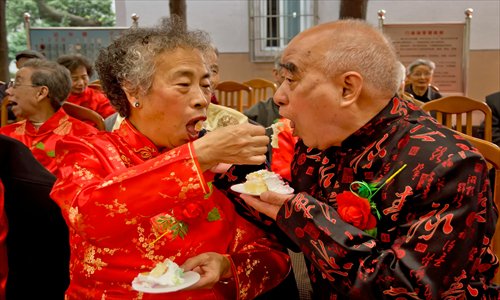An elderly couple offer each other cake at their wedding anniversary party in Ningbo, Zhejiang Province Monday, right before the Chongyang Festival on Tuesday, which celebrates senior citizens. Photo: CFP 