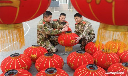 Soldiers prepare red lanterns to decorate their barrack for the coming Spring Festival in Fuyang City, east China's Anhui Province, Feb. 8, 2013. The Spring Festival, the most important occasion for the family reunion for the Chinese people, falls on the first day of the first month of the traditional Chinese lunar calendar, or Feb. 10 this year. Photo: Xinhua
