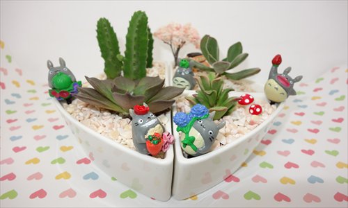 Totoro figurines frolic among succulent plants on a desktop planter. Photo: Courtesy of Wu Feifei