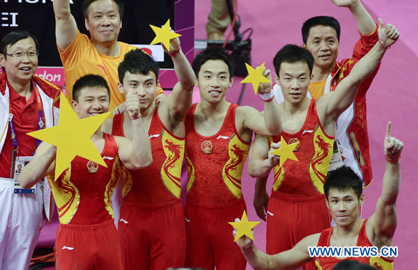 Chinese gymnasts celebrate after winning in Gymnastics Artistic men's team final contest, at London 2012 Olympic Games in London, Britain, on July 30, 2012. The Chinese team won gold medal. Photo: Xinhua
 