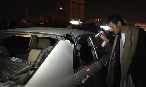 A Yemeni man inspects a damaged car following an attack on a Shiite group in Sanaa, Yemen, November 24, 2012. Twin bombs ripped through a gathering of a Muslim Shiite celebration in the northern Yemeni capital of Sanaa on Saturday, killing at least 4 people and injuring several others. Photo: Xinhua