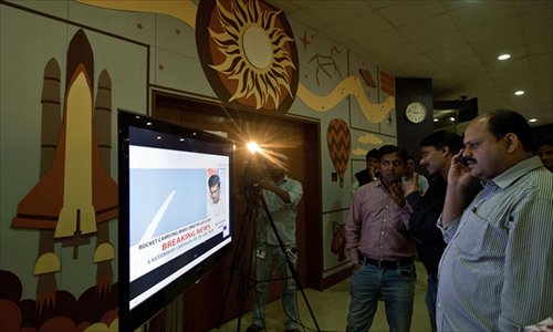 Indian visitors to the Nehru Planetarium watch the live telecast of the launch of India's Mars Orbiter Mission in New Delhi on Tuesday. The country aims to become the first Asian nation to reach the red planet with a program showcasing its low-cost space technology. Photo: AFP