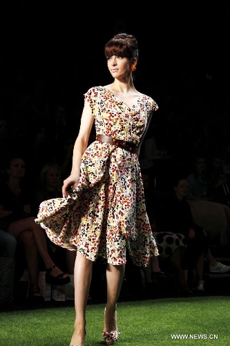 A model presents a creation by Austrian designer Lena Hoschek at the Spring/Summer 2014 Shows of the Mercedes-Benz Fashion Week, in Berlin, on July 2, 2013. (Xinhua/Pan Xu) 
