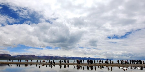 &nbsp; Tourists enjoy the scenery around the lake Nam Co located at the boundary of Damxung and Baingoin counties, southwest China's Tibet Autonomous Region, on Aug. 12, 2012. Lake Nam Co, the highest saltwater lake of the world at 4,718 meters above the sea level, is regarded as a sacred lake in Tibetan Buddhism. (Xinhua/Chen Tianhu)&nbsp; 