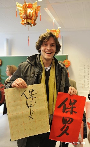 Paul shows a calligraphy work of his Chinese name during an event to celebrate the Spring Festival at the 4th Brussels European School in Brussels, capital of Belgium, on Feb. 2, 2013. The Chinese embassy in EU and the 4th Brussels European School held an event to introduce Chinese Spring Festival to hundreds of pupils and their parents Saturday.(Xinhua/Ye Pingfan) 