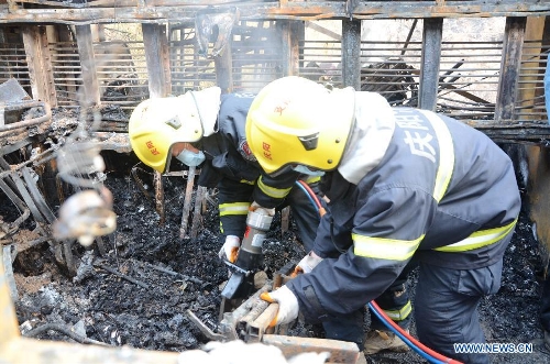 Rescuers work at the scene where a road accident occured in Ningxian County of Qingyang city, in northwest China's Gansu Province, Feb. 2, 2013. The death toll has risen to 13 as the rescuers found another five corpses at the accident site on Saturday morning. A bus tumbled into a ravine and caught fire on Friday night here in Gansu Province. (Xinhua)