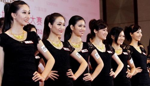 Photo taken on August 22, 2012 shows contestants selected for the final are in a show. The golden crown for Miss Universe 2012 China Zone final was revealed to the public on August 22, 2012. The crown, shaped like a peacock spreading its tail, was made of more than 600 diamonds and jewels. 21 contestants were chosen to join the final in September and the winner will join Miss Universe 2012 representing China in December. Photo: Xinhua