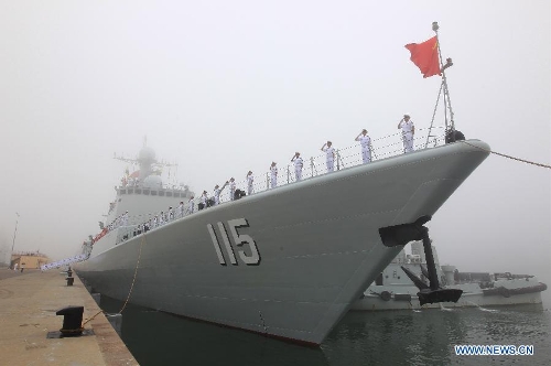 Officers and soldiers of Chinese navy take part in a ceremony for the departure of a fleet in the port of Qingdao, east China's Shandong Province, July 1, 2013. A Chinese fleet consisting of seven naval vessels departed from east China's harbor city of Qingdao on Monday to participate in Sino-Russian joint naval drills scheduled for July 5 to 12. The eight-day maneuvers will focus on joint maritime air defense, joint escorts and marine search and rescue operations. (Xinhua/Zha Chunming)