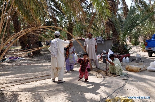 Pakistani earthquake survivors build makeshift shelters near their collapsed mud houses in southwest Pakistan's Mashkel area, April 19, 2013. Pakistani authorities on Thursday said that rescue operations had been speeded up in areas affected by the Tuesday's 7.9 magnitude earthquake in the country's southwestern province of Balochistan near Pakistan-Iran border. At least 40 people were killed and over 300 others injured in a 7.9-magnitude earthquake that hit Pakistan on Tuesday afternoon, an official with National Disaster Management Authority (NDMA) told Xinhua on Wednesday. (Xinhua/Asad) 