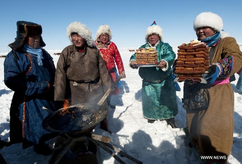 Herdsmen offer sacrifices to gods during the traditional livestock prosperity festival at Hexigten Banner in Chifeng, north China's Inner Mongolia Autonomous Region, Feb. 21, 2013. The festival is a special day typically held around the Spring Festival, on which nomadic Mongolians celebrates the 