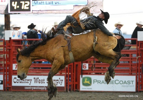 Matt Lait of Canada competes in Bareback Riding category at the annual Cloverdale Professional Rodeo 2013 in Cloverdale, BC, Canada, May 17, 2013. In 1984 the Cloverdale Rodeo was voted the Number One Performance Rodeo in North America by the Professional Rodeo Cowboy's Association. Today the Cloverdale Rodeo & Exhibition is the second largest community rodeo in Canada, attracting competitors and spectators worldwide. (Xinhua/Sergei Bachlakov) 