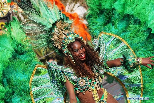 A performer takes part in the flowers parade during the 129th annual Nice Carnival parade, in Nice, southern France, March 2, 2013. (Xinhua/Gao Jing) 