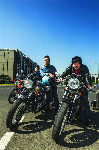 Retro Bikes Club members Yin Ziqi (left), Zhang Kun (middle) and Gao Xiaoyang (right) pose with their vintage Triumph motorcycles. Photo: Li Hao/GT
